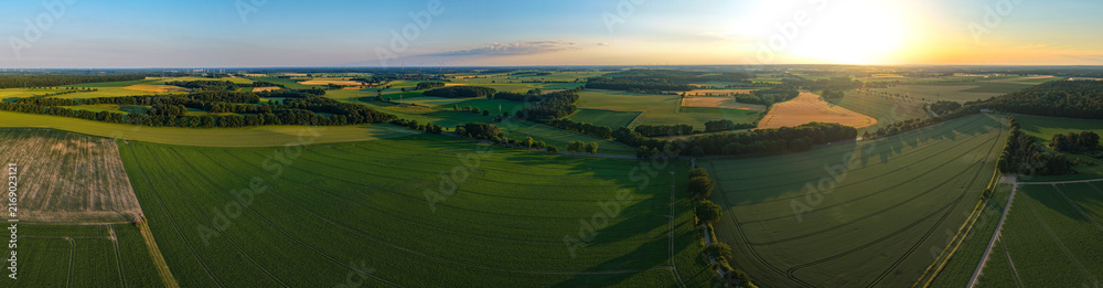 Fototapeta premium Aerial field panorama. Farming landscape panorama. Aerial rural countryside landscape with farmland field. Panoramic agricultural land and natural landscape. Panoramic aerial field, farm