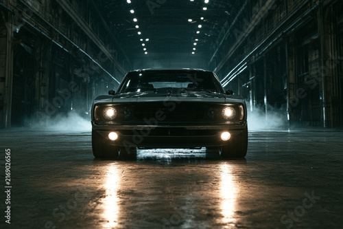 Cinematic muscle car parked in industrial warehouse
