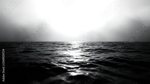 Dramatic monochrome ocean waves under a misty bright sky creating a vast atmospheric seascape