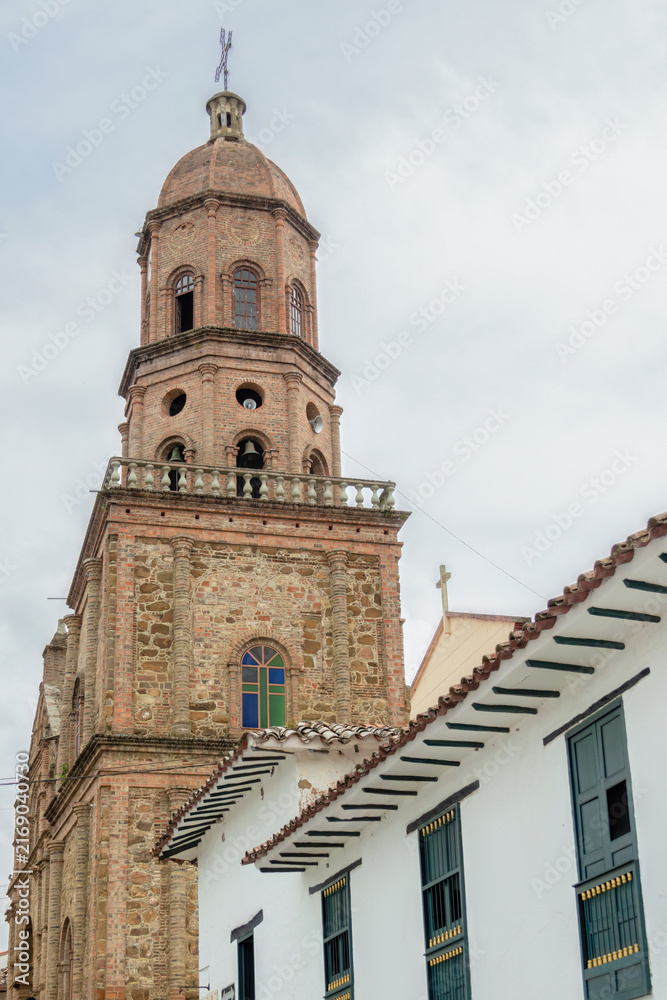 Fototapeta premium The old colonial style tower of the main church of the town of Curiti