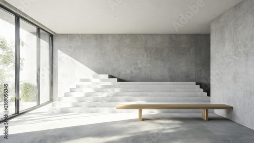 A bright, uncluttered modern interior space featuring concrete walls, stairs, a wooden bench, and large glass windows letting in natural daylight.
