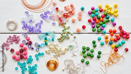 Assortment of colorful beads and crafting supplies for jewelry making