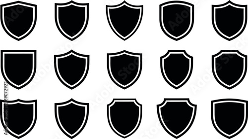 A collection of fifteen various black shield icons isolated on a white background representing security protection and heraldic design elements