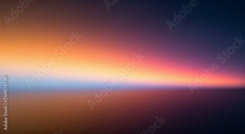 A blurred abstract gradient of warm and cool colors creates a soft atmospheric scene high-quality