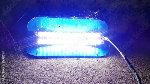Blue LED Light Switching On and Off, Bright Electric Glow in a Dark Environment
