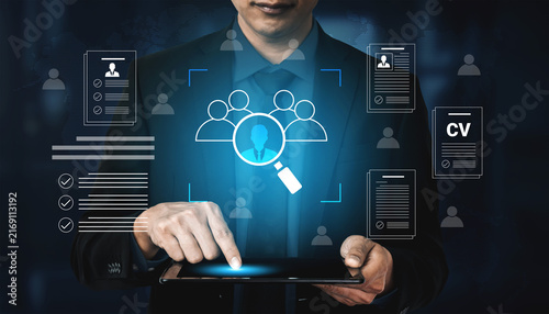 Obraz na płótnie A business professional engages with a tablet displaying recruitment data, highlighting the modern approach to CV analysis in a digital workspace filled with user interface elements