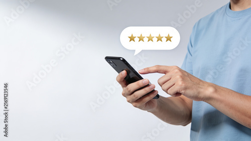 Man Using Smartphone With Five Star Customer Review Interface, Online Feedback and Customer Satisfaction Concept for Digital Business and Service Evaluation