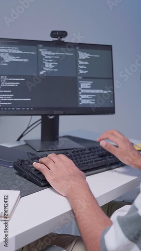 Software engineer wearing casual clothing typing on keyboard desktop computer information AI, management cybersecurity or coding software development. Programmer adult working artificial intelligence