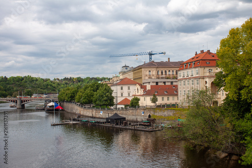Bild auf Leinwand view of the vltava river and old town in prague with a crane