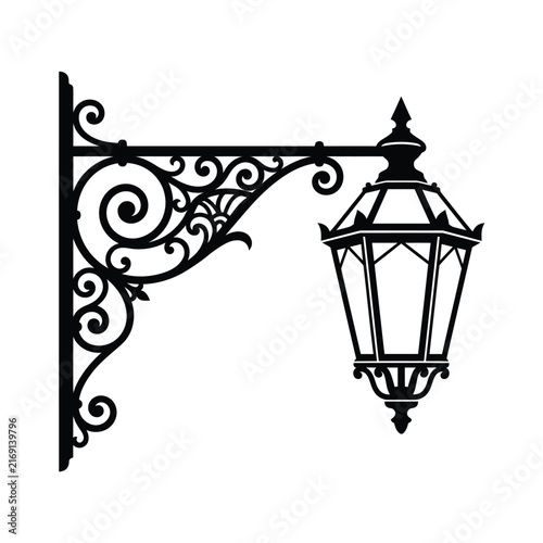 Classic black wall lamp with ornate scrollwork bracket and hanging element