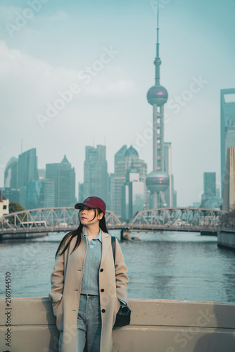 Photography Traveler in a maroon cap admires the Pudong skyline near Zhapu Bridge, Shanghai