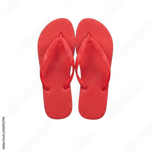 Pair of bright red rubber flip flops isolated on a white background for summer vacation.