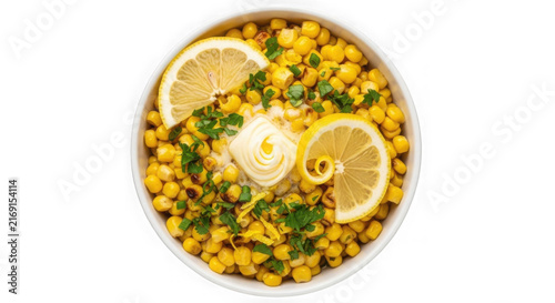 Bowl of sweet corn salad with lemon slices and cream topping on white background
