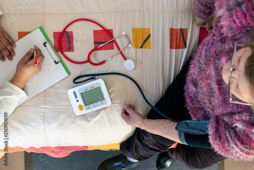 Blood pressure check for older woman in clinic