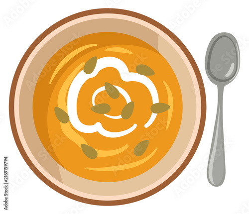 Creamy pumpkin soup bowl with seeds top view