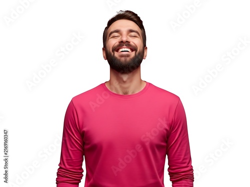 A joyful man with a beard smiling with his eyes closed in a pink shirt