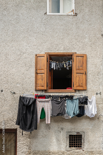 Alleghe, Italy. Traditional household laundry drying outside an old alpine house in the Dolomites