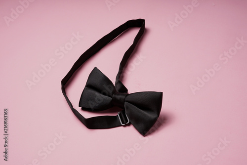 Elegant Black Bow Tie on Pink Pastel Background, Men's Formal Fashion Concept