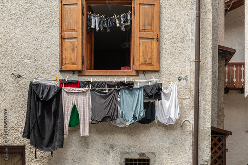 Alleghe, Italy. Laundry drying on a clothesline outside a traditional alpine house