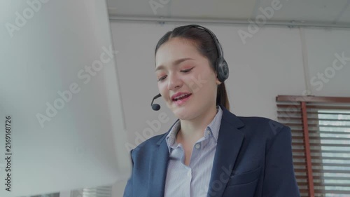 Call center operator assisting client with headset