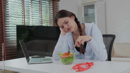 Unhappy woman eating salad for weight loss