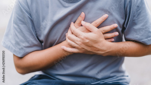 Quadro su tela Adult man suffering from acute chest pain outdoors, pressing both hands on his heart