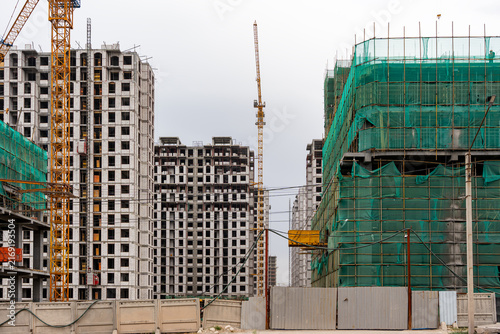 Obraz na plátně Urban development and construction boom with cranes in Bishkek city