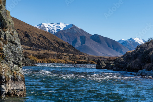 The Ahuriri braided river flowing through some rapids in the Ahuriri conservation valley area in Canterbury NZ