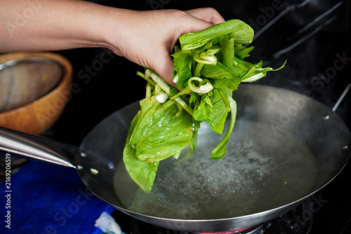 Fotografie Blanching Fresh Chinese Kale in Boiling Water During Home Cooking