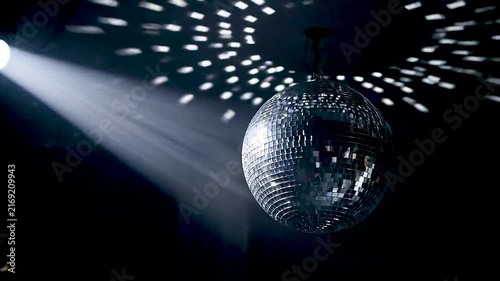 Disco ball reflecting light patterns on dark background.