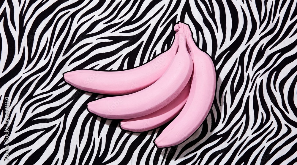 Naklejka premium Pink Bananas on a Black and White Zebra Stripe Background.