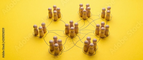 Wooden People Network Connected by Lines on Yellow Background