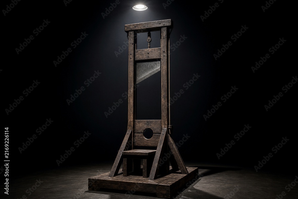 Naklejka premium Ancient wooden guillotine apparatus under single spotlight beam
