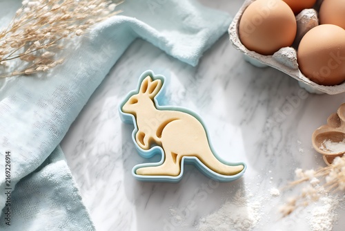 Kangaroo Cookie Cutter on Marble Surface with Eggs and Dried Flowers, a Culinary Still Life