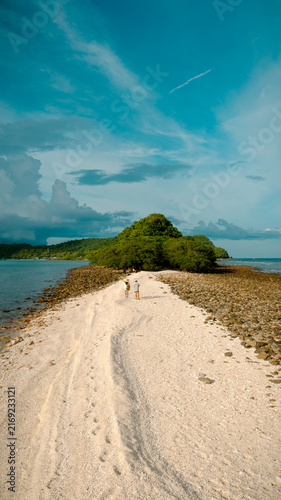 The couple traveler are working in the mid-ground of the sea summer on isolation island, tropical island traveling together