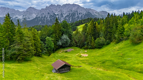Obraz na plátně Aerial drone view of beautiful summer landscape of green alpine meadow with trad