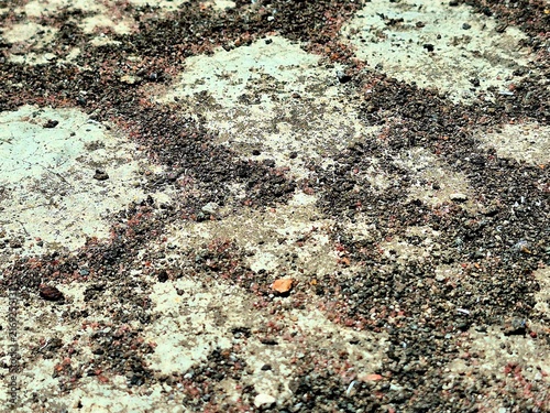 Abstract natural ground surface texture with dark sand and weathered stone