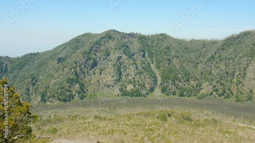 Panoramic view of rugged volcanic mountain landscape under clear blue sky in Italy.