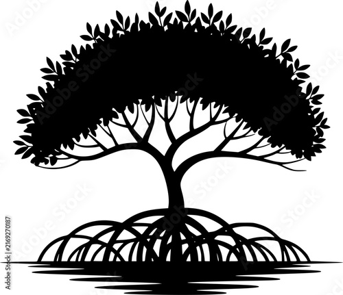 A black and white silhouette of a mangrove tree with intricate roots standing in shallow water