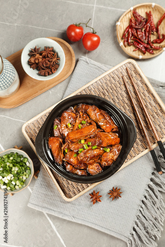 Hot braised goose meat stew in old iron pot with spices - traditional farmhouse cooking