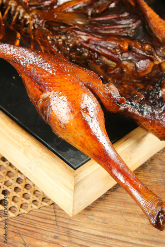 Traditional Chinese Roasted Goose Specialty from Liyang with Glossy Marinated Skin on Wooden Board
