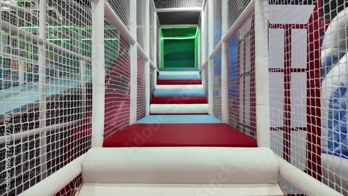 Colorful indoor soft play maze stairs and safety net bridge for children recreation.
