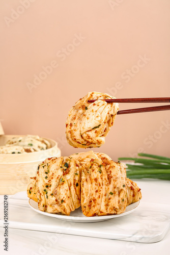 Принти на полотні Handmade Asian Meat Buns with Scallions Being Eaten with Chopsticks