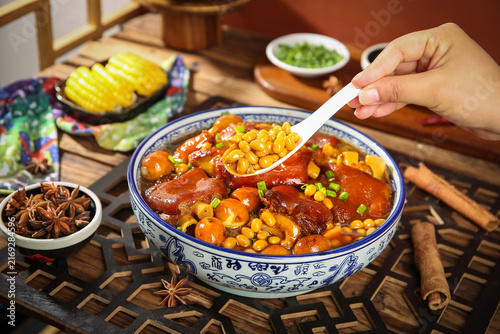 Bild auf Leinwand Chinese Braised Pork Knuckle with Soya Beans and Corn in Spicy Secret Sauce Trad