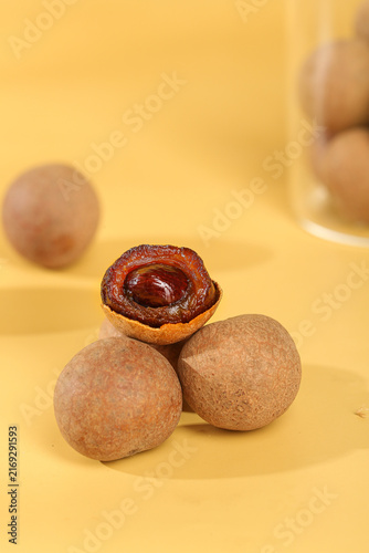 Dried Longan Fruits Asian Delicacy Traditional Chinese Medicine Healthy Snack Yellow Background