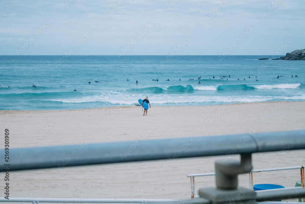 Fototapeta premium Zurriola beach in Donosti or San Sebastian with surfers in the background