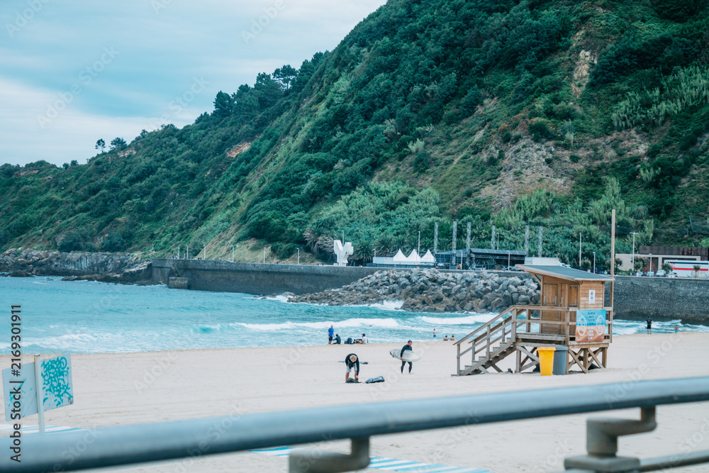 Fototapeta premium Zurriola beach in Donosti or San Sebastian with surfers in the background