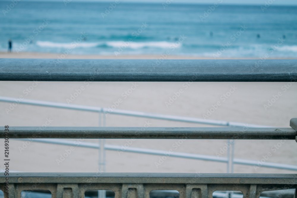 Fototapeta premium Zurriola beach in Donosti or San Sebastian with surfers in the background