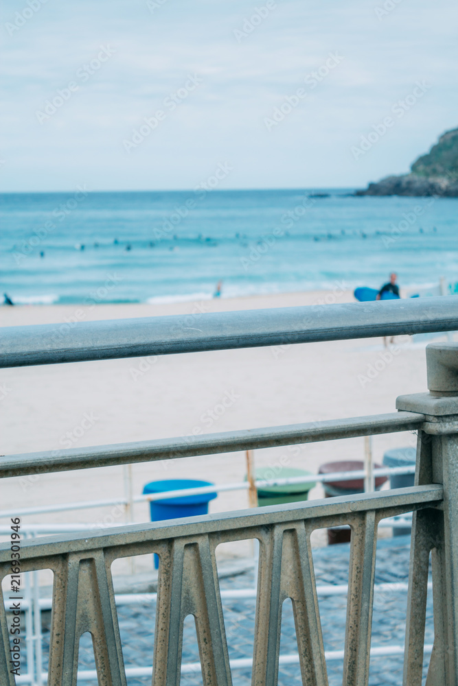 Naklejka premium Zurriola beach in Donosti or San Sebastian with surfers in the background