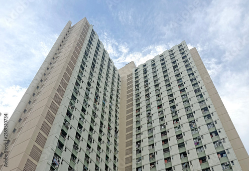 Hong Kong Towering residential building with many windows against cloudy sky